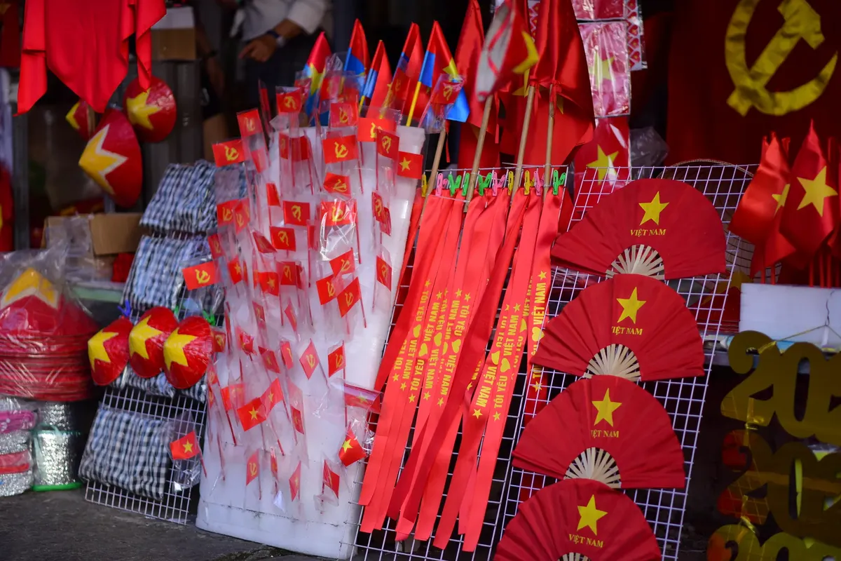 Colorful display of Vietnamese flags and fans celebrating national pride at a local market.